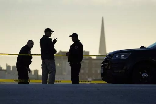 Police stand at the top of the closed street outside the home of House Speaker Nancy Pelosi and her husband Paul Pelosi in San Francisco, Friday, Oct. 28, 2022. Within hours of the attack on Paul Pelosi, conspiracy theories deflecting blame for the assault on the husband of U.S. Speaker Nancy Pelosi were already swirling online. (AP Photo/Eric Risberg, File)