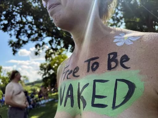 A rider poses at the start of the Philly Naked Bike Ride in Philadelphia, Saturday, Aug. 26, 2023. (AP Photo/Tassanee Vejpongsa)