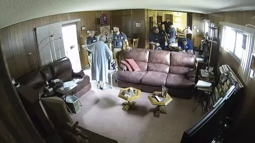 This screen grab of security camera footage provided by Eric Meyer shows his mother, Joan Meyer, ordering police officers to get out of her house as they searched it on Aug. 11, 2023, in Marion, Kan. Joan Meyer, who was 98, died the next day. Her son, Marion County Record Editor and Publisher Eric Meyer, blames his mother's death on the stress caused by the search. (Eric Meyer via AP)
