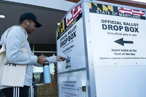A voter drops his ballot in a drop box at Marilyn J. Praisner Community Recreation Center, during Election Day on Nov. 8, 2022, in Burtonsville, Md. Lawmakers in several Democratic-controlled states are pushing sweeping voting protections this year, reacting to what they view as a broader assault on voting rights by the Supreme Court and Republican-led states. (AP Photo/Jose Luis Magana, File)
