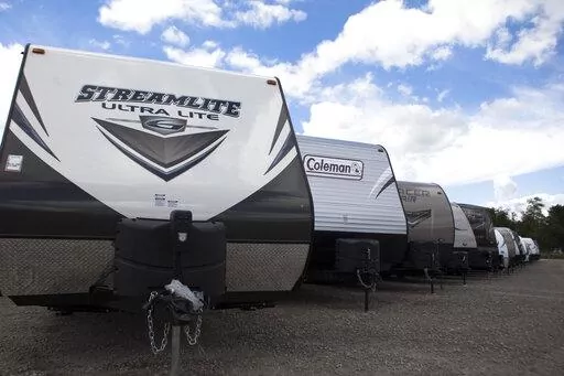 Recreational vehicles sit in a lot waiting for delivery at Horizon Transport in Wakarusa, Ind. on July 15, 2014. RV delivery is a growing trend that allows travelers to enjoy all of the conveniences of staying in an RV without actually having to drive it. Several companies offer delivery services for customers who rent, which can not only be more convenient, but also more affordable. (James Buck/The Elkhart Truth via AP)