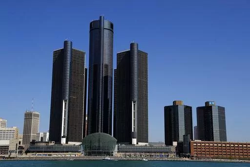 This May 12, 2020, file photo, shows a general view of the Renaissance Center, headquarters for General Motors, along the Detroit skyline from the Detroit River. General Motors will keep its headquarters in its seven-building office tower complex in downtown Detroit, its CEO says. Mary Barra, in an interview with The Associated Press, says the automaker’s main office will remain in the Renaissance Center, the centerpiece of the city’s skyline just across the Detroit River from Canada. (AP Ph
