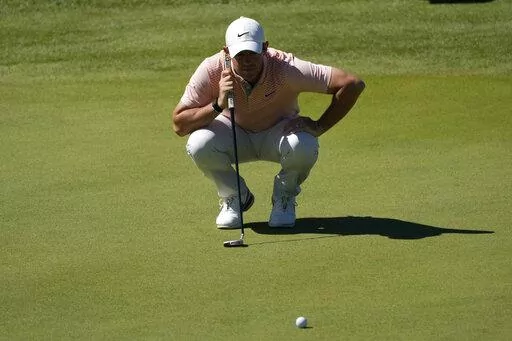 Rory McIlroy of Northern Ireland checks his golfball during the Italian Open golf tournament in Guidonia Montecelio, near Rome, Italy, Sunday, Sept. 18, 2022. The Italian Open took place on the Marco Simone course that will host the 2023 Ryder Cup. (AP Photo/Alessandra Tarantino)