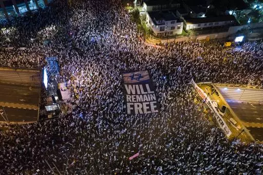 Tens of thousands of Israelis protest against plans by Prime Minister Benjamin Netanyahu's government to overhaul the judicial system in Tel Aviv, Israel, Saturday, April 15, 2023. As Israel turns 75, it has much to celebrate. But instead of feting its accomplishments as a regional and economic powerhouse, the nation founded as a home for the world's Jews in the wake of the Holocaust finds itself under threat -- not by foreign enemies but by bitter internal divisions. (AP Photo/Oded Balilty, Fil