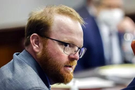 Travis McMichael is shown during the sentencing of he and his father Greg McMichael and neighbor, William "Roddie" Bryan in the Glynn County Courthouse, Friday, Jan. 7, 2022, in Brunswick, Ga. The man who fatally shot Ahmaud Arbery and his father have reached a plea deal that could avoid their trial on federal hate crime charges. Arbery's parents denounced the deal as a betrayal, and called on the judge to reject it. Court documents filed late Sunday, Jan. 30, 2022, by prosecutors for the U.S. J