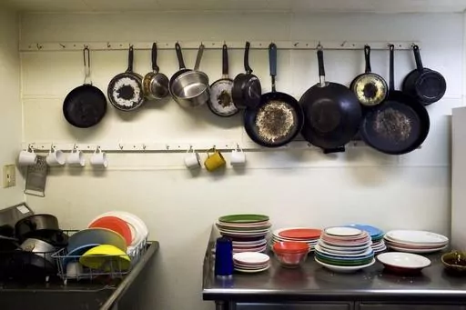 Pots and pans for use at the Venice Hostel are placed near a sink in Venice Beach, Los Angeles, Aug. 14, 2009. Airbnb may have met its match. There’s no shortage of customers who have sworn off the company after being ghosted by owners or hit with unexpected cleaning fees. Airbnb’s operation in New York City is severely restricted, given new regulations implemented in 2023. Meanwhile, hostels — which largely struggled during the pandemic amid concerns about sharing rooms — are back. (AP 