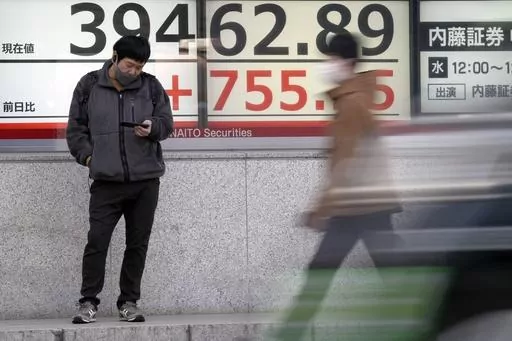 A person stands in front of an electronic stock board showing Japan's Nikkei 225 index at a securities firm Monday, March 18, 2024, in Tokyo. Asian stocks advanced Monday ahead of policy decisions this week by Japan’s central bank and the Federal Reserve. (AP Photo/Eugene Hoshiko)