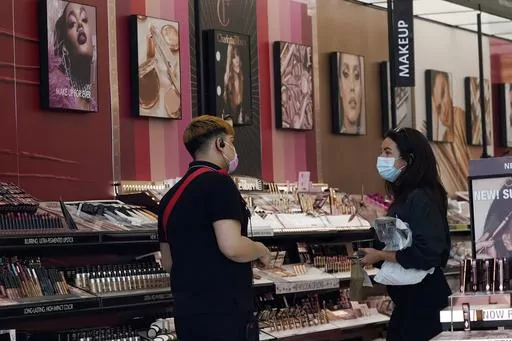 A worker, at left, tends to a customer at a cosmetics shop on Thursday, May 20, 2021, in Los Angeles.A growing number of state legislatures are considering banning the sale of cosmetics and other consumer products that contain the toxic industrial compound PFAS over health concerns. (AP Photo/Marcio Jose Sanchez, File)