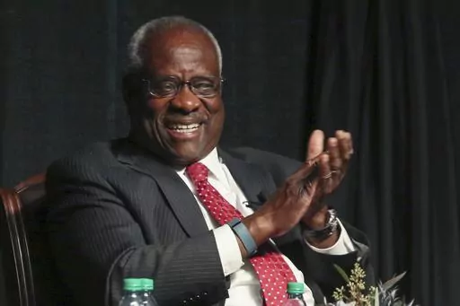Supreme Court Justice Clarence Thomas laughs before speaking to an audience at McLennan Community College in Waco, Texas, on Sept. 7, 2017. Records obtained by The Associated Press show that Supreme Court justices have attended publicly funded events at colleges and universities that allowed the schools to put the justices in the room with influential donors, including some whose industries have had interests before the court. (Rod Aydelotte/Waco Tribune-Herald via AP, File)