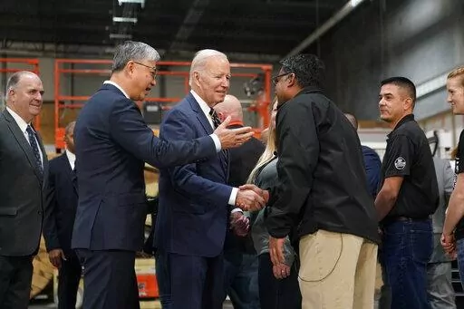 President Joe Biden tours SK Siltron CSS, a computer chip factory in Bay City, Mich., Tuesday, Nov. 29, 2022, with SK Siltron CSS CEO Jianwei Dong, second left. (AP Photo/Patrick Semansky)