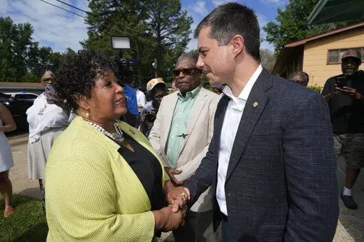 Reena Evers-Everette, front left, daughter of assassinated civil rights leader Medgar Evers, left, welcomes U.S. Transportation Secretary Pete Buttigieg, front right, and Mississippi Transportation Commissioner for the Central District Willie Simmons, center, to the home of her father, assassinated civil rights leader Medgar Evers, Friday, June 21, 2024, in Jackson, Miss. The house, now the Medgar and Myrlie Evers National Monument, was one of the stops Buttigieg made as he spent Thursday and Fr
