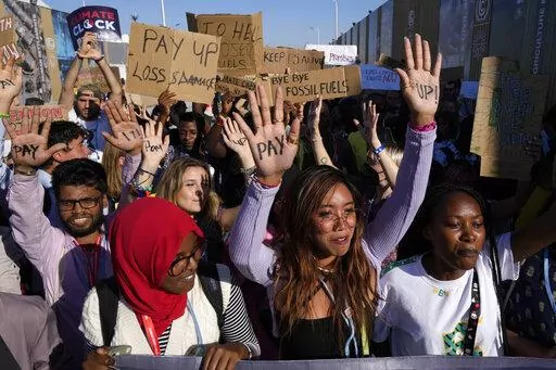 Mitzi Jonelle Tan, center, of the Philippines, participates in a demonstration at the COP27 U.N. Climate Summit, Nov. 18, 2022, in Sharm el-Sheikh, Egypt. (AP Photo/Peter Dejong, File)