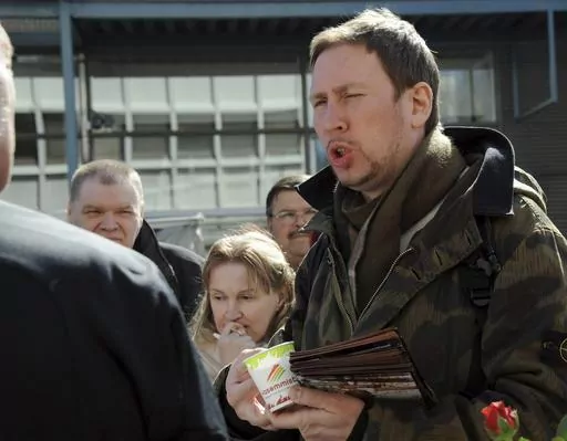 Paavo Arhinmaki, right, then leader of The Left Alliance and candidate for the Finnish Parliament, meets with voters during the party's election campaign in Helsinki, Finland, Saturday April 16, 2011. The current deputy mayor of Finland’s capital Arhinmaki is facing possible legal action, and calls for him to pay compensation for damages and to resign, after he was caught red-handed spray-painting graffiti in a railway tunnel on Friday, June 23, 2023. (Sari Gustafsson/Lehtikuva via AP, File)