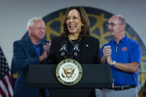 Democratic presidential nominee Vice President Kamala Harris, with Democratic vice presidential nominee Minnesota Gov. Tim Walz, left, and UAW President Shawn Fain, speaks at a campaign rally at UAW Local 900, Aug. 8, 2024, in Wayne, Mich. (AP Photo/Julia Nikhinson, File)