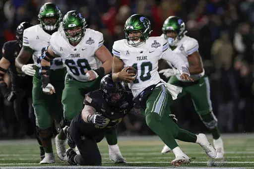 Tulane quarterback Darian Mensah (10) carries the ball against Army during the first quarter of the American Athletic Conference championship NCAA college football game Friday, Dec. 6, 2024, in West Point, N.Y. (AP Photo/Adam Hunger)