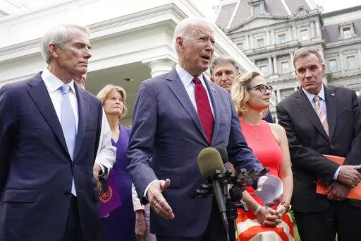President Joe Biden, with a bipartisan group of senators speaks June 24, 2021, outside the White House in Washington. Biden invited members of the group of 21 Republican and Democratic senators to discuss the infrastructure plan. From left are, Sen. Rob Portman, R-Ohio, Sen. Lisa Murkowski, R-Alaska, Biden, Sen. Joe Manchin, D-W.Va., Sen. Kyrsten Sinema, D-Ariz. and Se. Mark Warner, D-Va. (AP Photo/Jacquelyn Martin, File)
