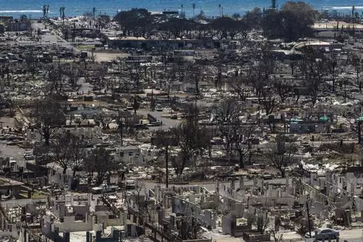Charred remains of homes are visible following a wildfire in Lahaina, Hawaii, Aug. 22, 2023. The number of people still missing following wildfires that destroyed the historic community of Lahaina a month ago has dropped, Hawaii Gov. Josh Green said Friday, Sept. 8, 2023, while the number of confirmed deaths has remained at 115. (AP Photo/Jae C. Hong, File)