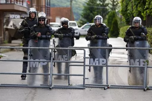 Polish soldiers, part of the peacekeeping mission in Kosovo KFOR, guard a municipal building in the town of Zvecan, northern Kosovo, Tuesday, May 30, 2023. Troops from the NATO-led peacekeeping force in Kosovo have used metal fences and barbed wire to beef up positions in a northern town following clashes with ethnic Serbs that left 30 soldiers wounded. (AP Photo/Marjan Vucetic)(AP Photo/Marjan Vucetic)