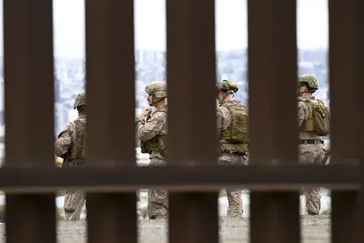 U.S. Marines deploy along the U.S.-Mexico border near the San Ysidro Port of Entry, Friday, Feb. 7, 2025, in San Diego. Tijuana, Mexico in seen in the background. (AP Photo/Denis Poroy)