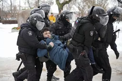 Police detain a man trying to lay flowers to honor Alexei Navalny at a monument in St. Petersburg, Russia, to victims of Soviet repression, on Saturday, Feb. 17, 2024. Over the last decade, Vladimir Putin's Russia evolved from a country that tolerates at least some dissent to one that ruthlessly suppresses it. Arrests, trials and long prison terms — once rare — are commonplace. (AP Photo, File)