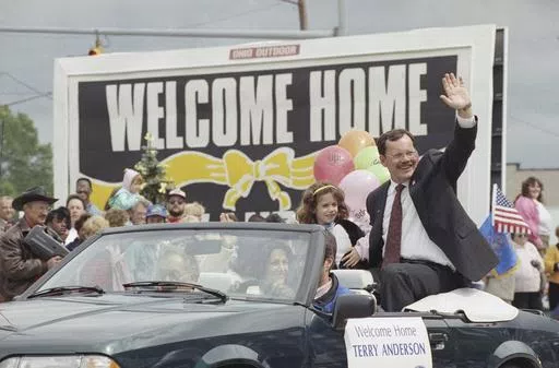 Former hostage Terry Anderson waves to the crowd as he rides in a parade in Lorain, Ohio, June 22, 1992. Anderson, the globe-trotting Associated Press correspondent who became one of America’s longest-held hostages after he was snatched from a street in war-torn Lebanon in 1985 and held for nearly seven years, died Sunday, April 21, 2024. He was 76. (AP Photo/Mark Duncan, File)