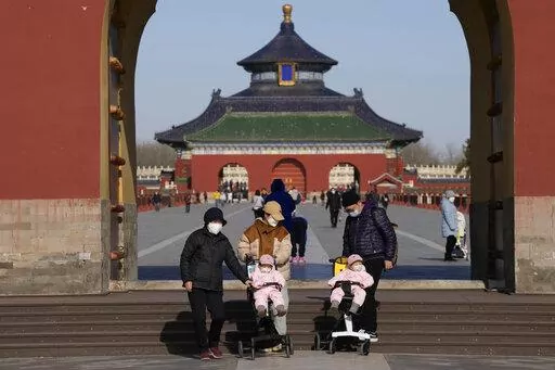 Visitors wear masks as they visit the Temple of Heaven park in Beijing, Thursday, Dec. 8, 2022. In a move that caught many by surprise, China announced a potentially major easing of its rigid "zero-COVID" restrictions, without formally abandoning the policy altogether. (AP Photo/Ng Han Guan)