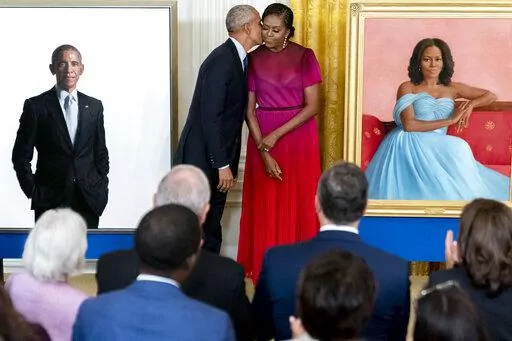 Former President Barack Obama kisses his wife former first lady Michelle Obama after they unveiled their official White House portraits during a ceremony in the East Room of the White House, Wednesday, Sept. 7, 2022, in Washington. (AP Photo/Andrew Harnik)