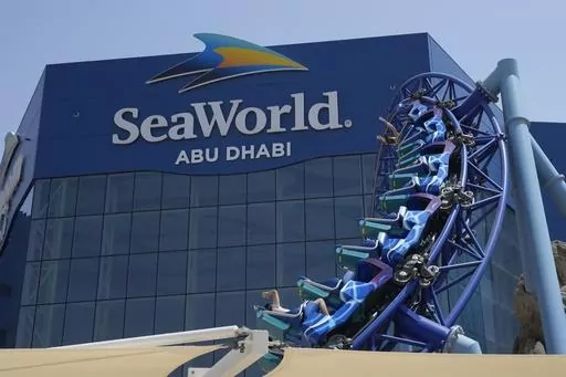 People enjoy riding on a roller coaster at the SeaWorld on Yas Island in Abu Dhabi, United Arab Emirates, on May 26, 2023. It’s the first venture outside the United States for the theme park chain, which had been mired in controversy in recent years over the treatment of captive killer whales. The $1.2 billion Abu Dhabi venture with state-owned developer Miral features the world's largest aquarium and cylindrical LED screen, as well as state-of-the-art facilities housing dolphins, seals, and o