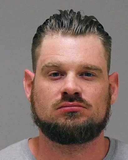 In a photo provided by the Kent County Sheriff, Adam Dean Fox is shown in a booking photo. Jury selection begins Tuesday, March 8, 2022, in the trial of four men who are accused of conspiring to snatch Michigan Gov. Gretchen Whitmer in a stunning scheme to retaliate against her stay-home policies and other COVID-19 restrictions during the early months of the pandemic. (Kent County Sheriff via AP File)