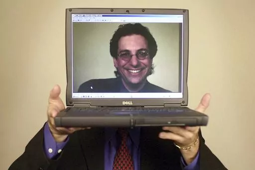Computer hacker turned author Kevin Mitnick poses for a portrait Thursday, June 27, 2002, in Las Vegas. Mitnick, whose pioneering antics tricking employees in the 1980s and 1990s into helping him steal software and services from big phone and tech companies made him the most celebrated U.S. hacker, has died at age 59. (AP Photo/Joe Cavaretta, File)