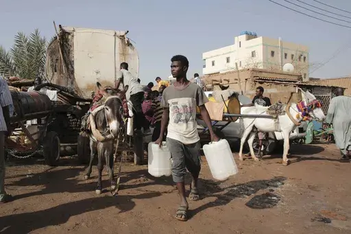 People gather to collect water in Khartoum, Sudan, May 28, 2023. (AP Photo/Marwan Ali, File)