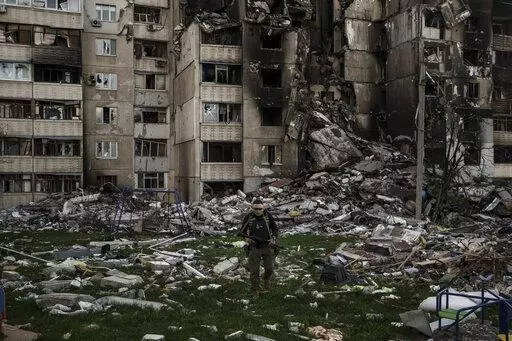 A Ukrainian serviceman walks amid the rubble of a building heavily damaged by multiple Russian bombardments near a frontline in Kharkiv, Ukraine, Monday, April 25, 2022. (AP Photo/Felipe Dana)