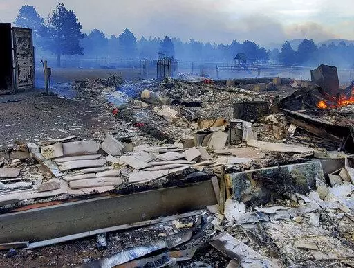 This Wednesday April 20, 2022, photo provided by Bill Wells shows his home on the outskirts of Flagstaff, Ariz., destroyed by a wildfire on Tuesday, April 19, 2022. The wind-whipped wildfire has forced the evacuation of hundreds of homes and animals. (Bill Wells via AP)