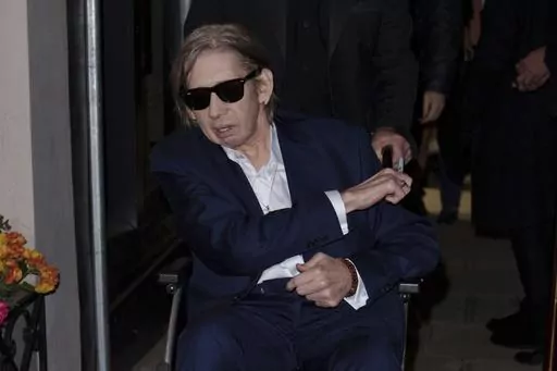 Shane MacGowan poses for photographers upon arrival at the Shane MacGowan, The Eternal Buzz & The Crock of Gold Exhibition in London, Tuesday, Oct. 11, 2022. Shane MacGowan, lead singer of The Pogues and best known for 'Fairytale of New York,' has died at 65, his wife said on Thursday, Nov. 30, 2023. (Photo by Scott Garfitt/Invision/AP, File)