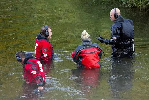 Water Recovery authorities comb the Apple River with metal detectors after five people were stabbed while tubing down the river, Saturday, July 30, 2022, in Somerset, Wis. (Alex Kormann/Star Tribune via AP)