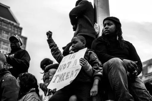 Residents of Baltimore gather during the community’s response to the 2015 in-custody death of Freddie Gray. The photo is part of a collection called “the Impact of Images” collection curated by Lead With Love, in collaboration with the studio and production company behind the film “Till.”  (Devin Allen via AP)