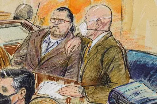 This artist sketch depicts Guy Wesley Reffitt, joined by his lawyer William Welch, right, in Federal Court, in Washington, on Feb. 28, 2022.  Reffitt, convicted of storming the U.S. Capitol with a holstered handgun helmet and body armor was sentenced on Monday to 87 months — more than seven years — in prison. It's the longest sentence imposed so far among hundreds of Capitol riot cases. (Dana Verkouteren via AP, File)