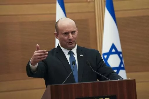 Israeli Prime Minister Naftali Bennett speaks during a joint statement with Foreign Minister Yair Lapid, at the Knesset, Israel's parliament, in Jerusalem, Monday, June 20, 2022. Bennett's office announced Monday, that his weakened coalition will be disbanded and the country will head to new elections. Bennett and his main coalition partner, Yair Lapid, decided to present a vote to dissolve parliament in the coming days, Bennett's office said. Lapid is then to serve as caretaker prime minister. 