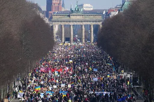 People attend a pro-Ukraine protest rally in Berlin, Germany, Sunday, March 13, 2022. On Thursday, Feb. 24, 2022 Russian troops have launched their anticipated attack on Ukraine. (AP Photo/Michael Sohn)