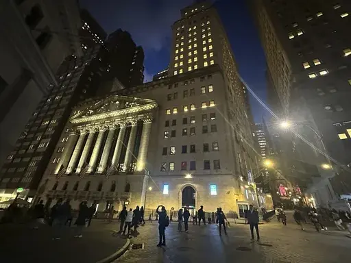 People walk past the New York Stock Exchange on Nov. 26 2024. (AP Photo/Peter Morgan, File)