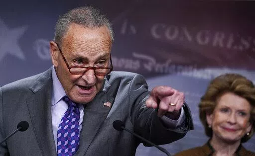 Senate Majority Leader Chuck Schumer, D-N.Y., joined at right by Sen. Debbie Stabenow, D-Mich., meets with reporters following a closed-door caucus lunch, at the Capitol in Washington, Tuesday, July 19, 2022. (AP Photo/J. Scott Applewhite)