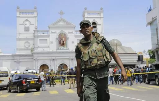 FILE- In this April 21, 2019 file photo, Sri Lankan army soldiers secure the area around St. Anthony's Shrine after a blast on Easter Sunday in Colombo, Sri Lanka. Sri Lanka’s president said Sunday he will appoint a committee chaired by a retired Supreme Court judge to investigate allegations made in a British television report that the South Asian country’s intelligence was complicit in the 2019 Easter Sunday bombings that killed 269 people. (AP Photo/Eranga Jayawardena, File)