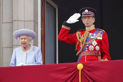 Queen Elizabeth II and the Duke of Kent watch from the balcony of Buckingham Palace after the Trooping the Color ceremony in London, Thursday, June 2, 2022, on the first of four days of celebrations to mark the Platinum Jubilee. The events over a long holiday weekend in the U.K. are meant to celebrate the monarch's 70 years of service. (Jonathan Brady/Pool Photo via AP)