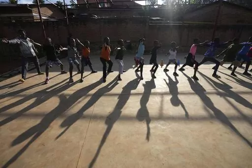 Children practise fencing game, on the outskirts of Kigali, Rwanda, Tuesday, April 4, 2024. The country will commemorate on April 7, 2024 the 30th anniversary of the genocide when ethnic Hutu extremists killed neighbours, friends and family during a three-month rampage of violence aimed at ethnic Tutsis and some moderate Hutus, leaving a death toll that Rwanda puts at 1,000,050. (AP Photo/Brian Inganga)