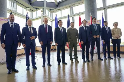 President Joe Biden, third from left, and Ukrainian President Volodymyr Zelenskyy, center, and other G7 leaders pose for a photo before a working session on Ukraine during the G7 Summit in Hiroshima, Japan, Sunday, May 21, 2023. Other leaders from right to left, European Commission President Ursula von der Leyen, Britain's Prime Minister Rishi Sunak, Canada's Prime Minister Justin Trudeau, France's President Emmanuel Macron, Zelenskyy, Japan's Prime Minister Fumio Kishida, Biden, German Chancell