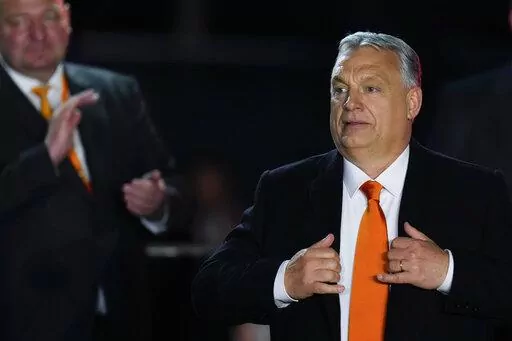Hungary's Prime Minister Viktor Orban acknowledges cheering supporters during an election night rally in Budapest, Hungary, Sunday, April 3, 2022. Early partial results in Hungary's national election are showing a strong lead for the right-wing party of pro-Putin nationalist Orban as he seeks a fourth consecutive term. (AP Photo/Petr David Josek)