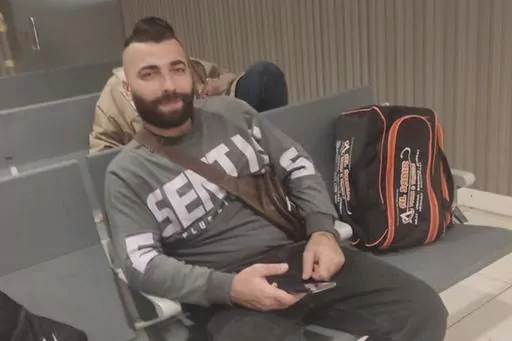 In this photo from May 2023 by a relative, Ali Sheikhi, 29, poses for a photograph at an airport in an undisclosed location. Sheikhi was trying to reach Europe from Libya on an overcrowded fishing vessel that capsized in the Mediterranean in the early hours of June 14, 2023, killing dozens of people, 104 passengers are rescued, and hundreds are feared to be missing. Sheikhi's relatives in Germany and Syria told The Associated Press they had recognized Ali Sheikhi among the survivors taken to a s