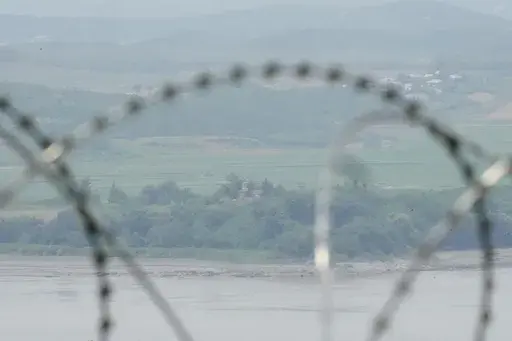 North Korea's military guard post is seen through the wire fences in Paju, South Korea, Friday, June 21, 2024. On Friday, South Korea’s military said it had fired warnings shots the previous day to repel several North Korean soldiers who briefly crossed the military demarcation line that divides the countries while engaging in unspecified construction work. Because of an overgrowth of foliage, the North Koreans may not have seen the signs marking the thin military demarcation line that divides