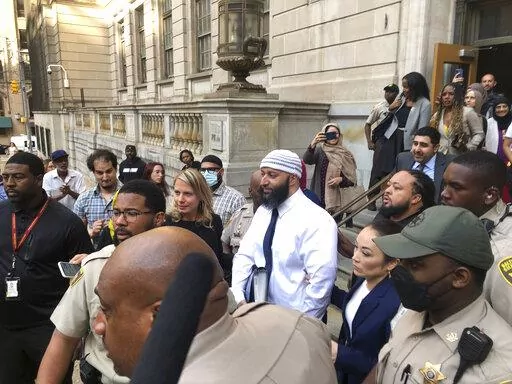 Adnan Syed, center, leaves the Elijah E. Cummings Courthouse, Monday, Sept. 19, 2022, in Baltimore. A judge has ordered the release of Syed after overturning his conviction for a 1999 murder that was chronicled in the hit podcast “Serial.” (AP Photo/Brian Witte)