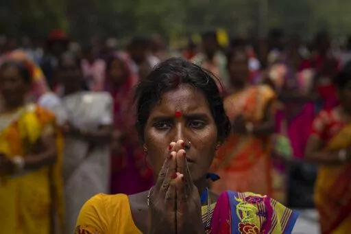 A tribes woman prays during a sit-in demonstration rally to demand of recognizing Sarna Dharma as a religion in Ranchi, capital of the eastern Indian state of Jharkhand, Oct. 18, 2022. Tribal groups have held protests in support of giving Sarna Dharma official religion status in the run-up to the upcoming national census, which has citizens state their religious affiliation. (AP Photo/Altaf Qadri)